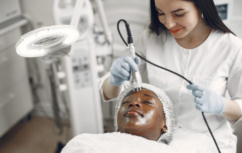 Girl doing facial procedures to beautician
