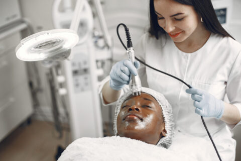Girl doing facial procedures to beautician
