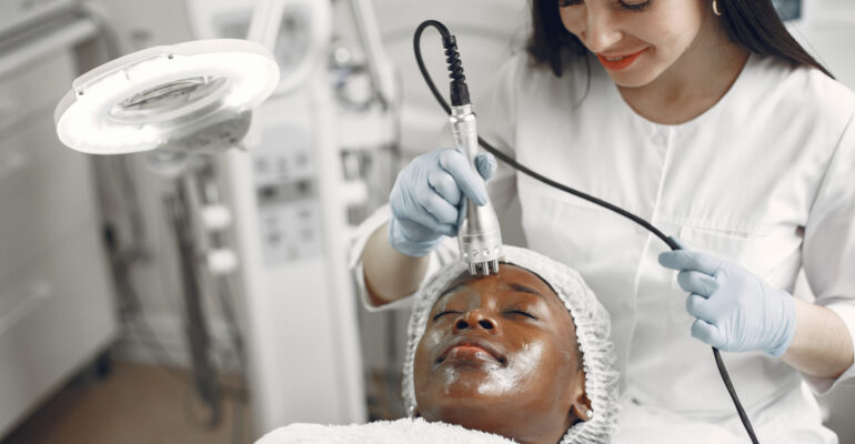 Girl doing facial procedures to beautician